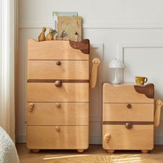 two wooden dressers sitting next to each other in a room with white walls and wood flooring