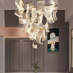 a chandelier hanging from the ceiling in a dining room