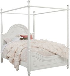 a white bed with four posts and pillows on it's headboard, in front of a white background