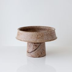 a marble bowl sitting on top of a white table