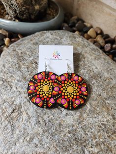 These unique wooden mandala earrings are a stunning piece of wearable art that will make a great addition to your accessory collection! Dress them up or wear them casually either way they are sure to suit every occasion. The wooden discs are hand painted dot by dot and sealed for shine and protection and they are light weight which makes them very comfortable to wear! The hand painted discs come on a shepherd hook style earrings The total drop of earring is approx 7cm with each disc measuring 5cm. If you love this design but would like it in a different colour please feel free to message me and I will be more than happy to chat with you about creating something for you. Note: *This is a loving handmade piece and is classed as costume jewellery, It should be handled with care and never subm Painted Discs, Dot By Dot, Mandala Earrings, Main Point, Shepherds Hook, Hand Painted Earrings, Painted Earrings, Dots Art, Style Earrings