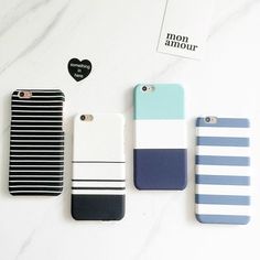 four different colored cases sitting next to each other on a white surface with black and blue stripes