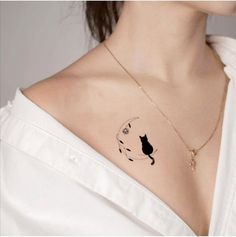 a woman with a cat tattoo on her chest