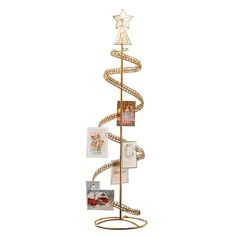 a gold metal christmas tree with pictures on it's sides and a star hanging from the top