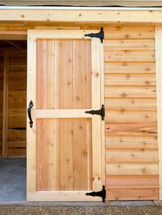 an open wooden garage door with black handles