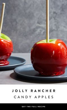 two apples with toothpicks sticking out of them sitting on plates next to each other