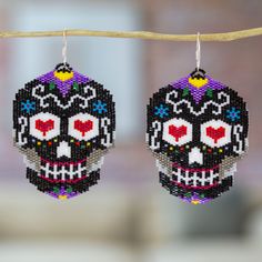 two beaded sugar skull earrings hanging from a string