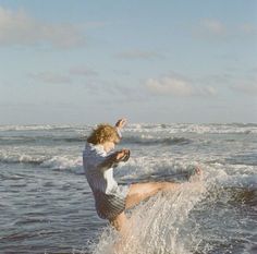 a young man riding a wave on top of a surfboard