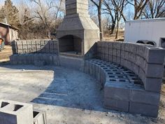 an outdoor fireplace made out of cinder blocks