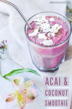 acai and coconut smoothie in a glass with a spoon next to it on a table