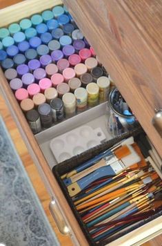 an open drawer filled with lots of art supplies