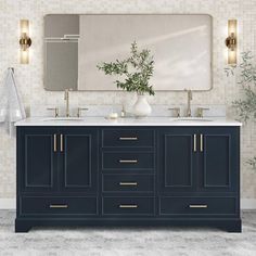 a bathroom vanity with two sinks and a large mirror above it, next to a potted plant