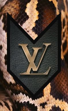 the louis vuitton logo on a snake skin background