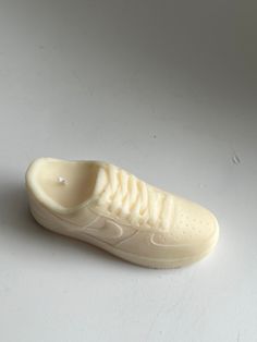 a white sneaker shoe is shown on a plain surface with only the bottom part visible