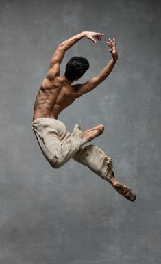 a shirtless male dancer in the air