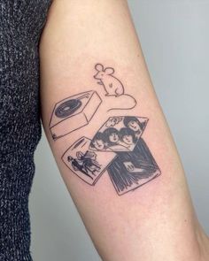 a woman's arm with an image of the beatles on it and some pictures