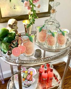 a bar cart with drinks and snacks on it