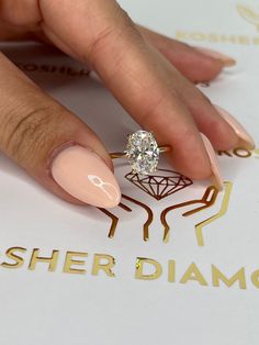 a woman's manicured nails with a diamond ring