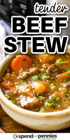 a bowl filled with beef stew on top of a wooden table