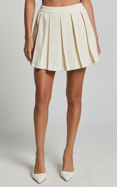 Maggie Mini Skirt - Pleated Mid Rise Boucle Skirt in Cream | Showpo USA Chic Spring Tennis Skirt, Pleated Hem Short Bottoms For Day Out, Chic Pleated Skort, Chic Pleated Tennis Skirt, Short Pleated Hem Bottoms For Day Out, Short Length Bottoms With Pleated Hem For Day Out, Short Length Pleated Hem Bottoms For Day Out, Chic Pleated Waist Mini Bottoms, Chic Pleated Waist Mini Length Bottoms