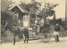 an old black and white photo of people riding in a horse drawn carriage