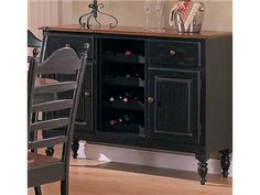 a dining room table and chairs with a wine rack