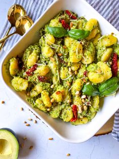 a white bowl filled with pesto and shrimp