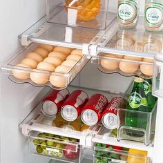 an open refrigerator with eggs, drinks and condiments on the shelves in it