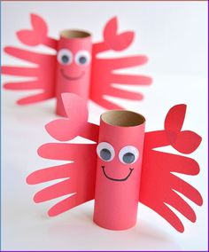 four red paper tubes with faces and arms