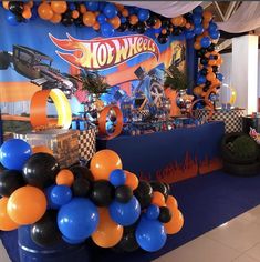 an assortment of balloons and decorations for a hot wheels birthday party