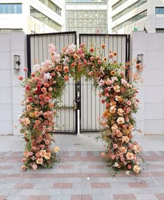 two gates decorated with flowers and greenery