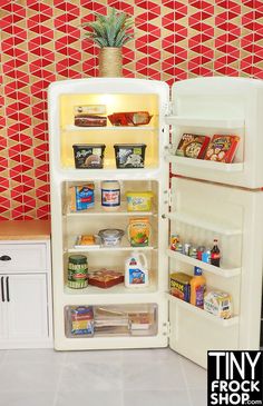 an open refrigerator with food in it next to a wallpapered red and white tile