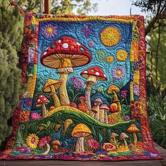 a quilted table runner with mushrooms and sunflowers in the background on a wooden deck