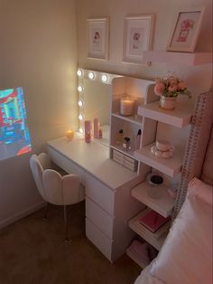 a bedroom with a vanity, mirror and lights on it's side table in front of a window