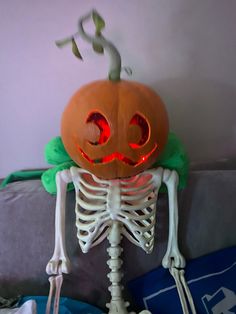 a skeleton with a pumpkin on it's head