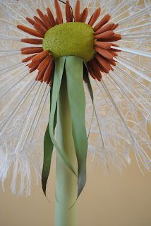 a large white flower with long green stems