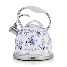 a blue and white tea kettle with flowers on it