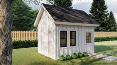 a small white shed sitting on top of a lush green field next to a tree