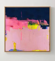 an abstract painting with pink, yellow and blue colors on a white wall above a wooden frame