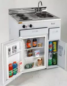 an open refrigerator with the door wide open and food in it's bottom compartment