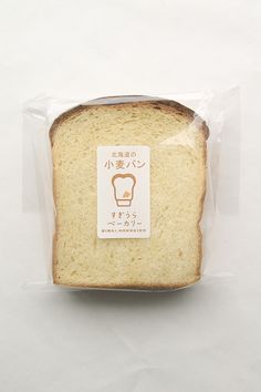 a piece of bread wrapped in plastic on a white surface