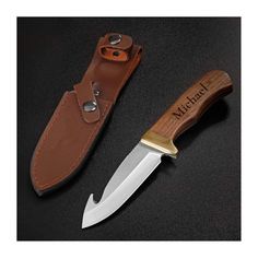 a knife with a leather sheath on it next to an open pocket knife holder that has the word, michael written on it