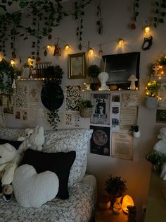 a living room filled with lots of plants and stuffed animals on the wall next to it