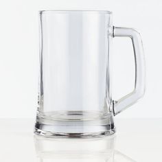 a glass mug sitting on top of a table