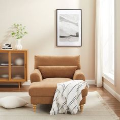 a living room with a brown chair and white rug