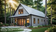 a small house in the middle of some trees and grass with text overlay that reads pole barns & barn homes