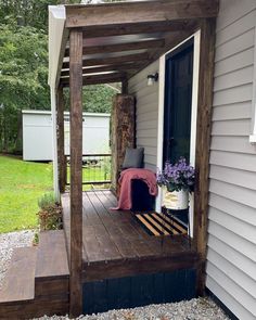 a wooden porch with a dog house on it