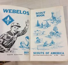 an old book is opened to show the boy scouts