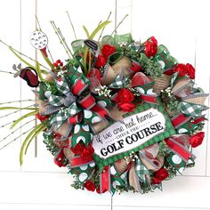 the wreath is decorated with red and green ribbons