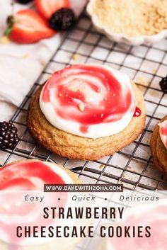 strawberry cheesecake cookies on a cooling rack with berries